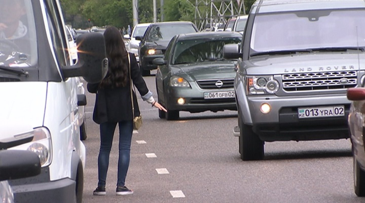 Hailing taxis on streets in Kazakhstan